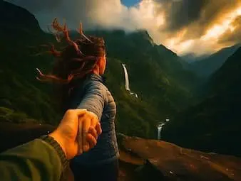 Traveller leading toward a waterfall valley on the Meghalaya offbeat tour